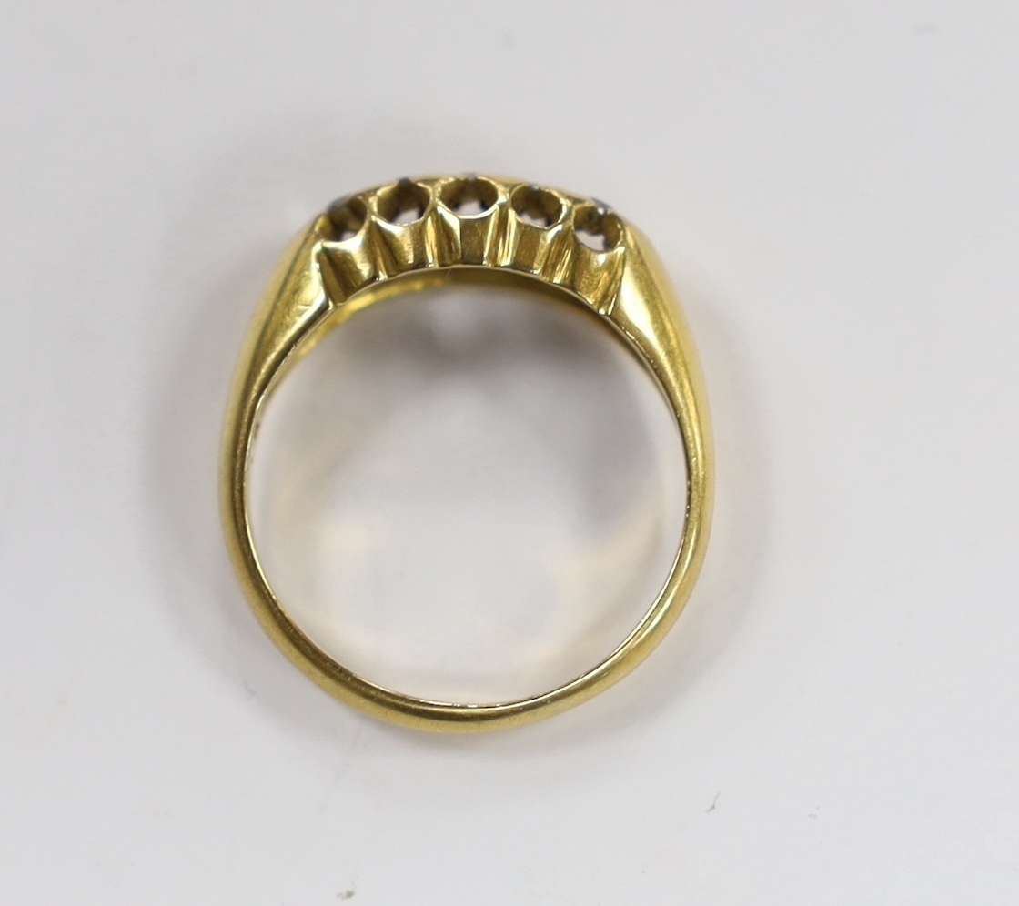 A George V 18ct gold and five stone diamond chip set half hoop ring, size M, gross weight 3.1 grams.